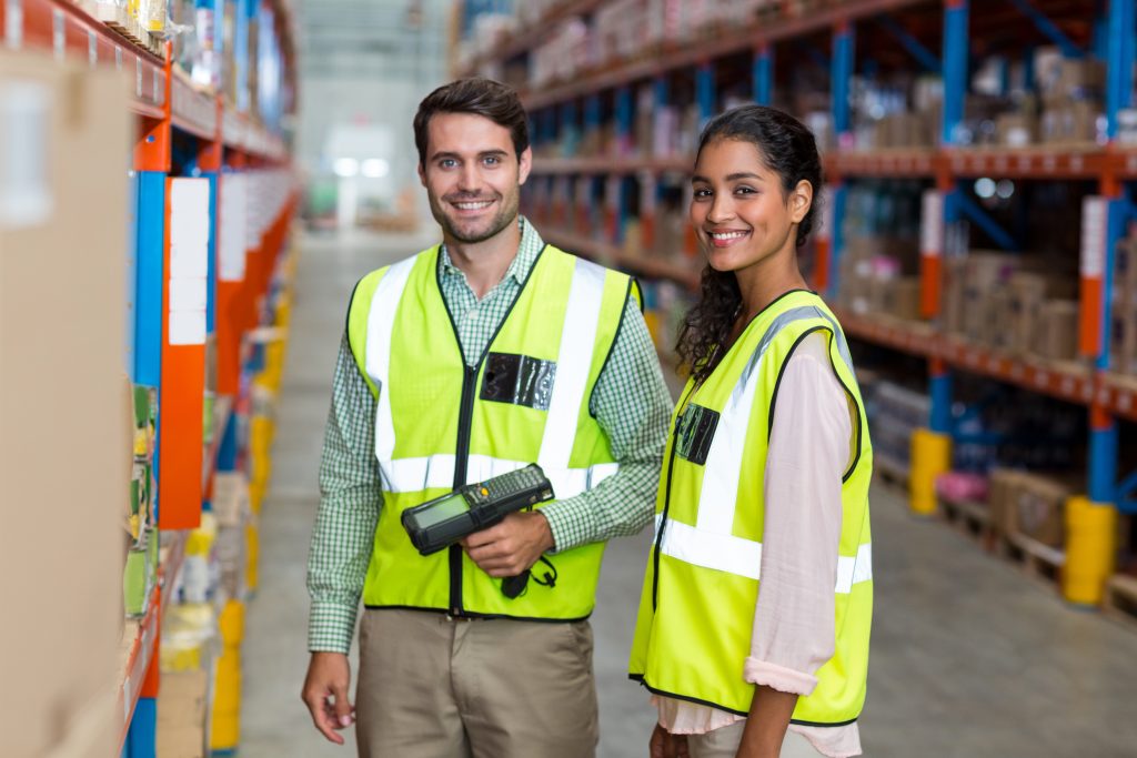 Male and Female warehouse workers smiling